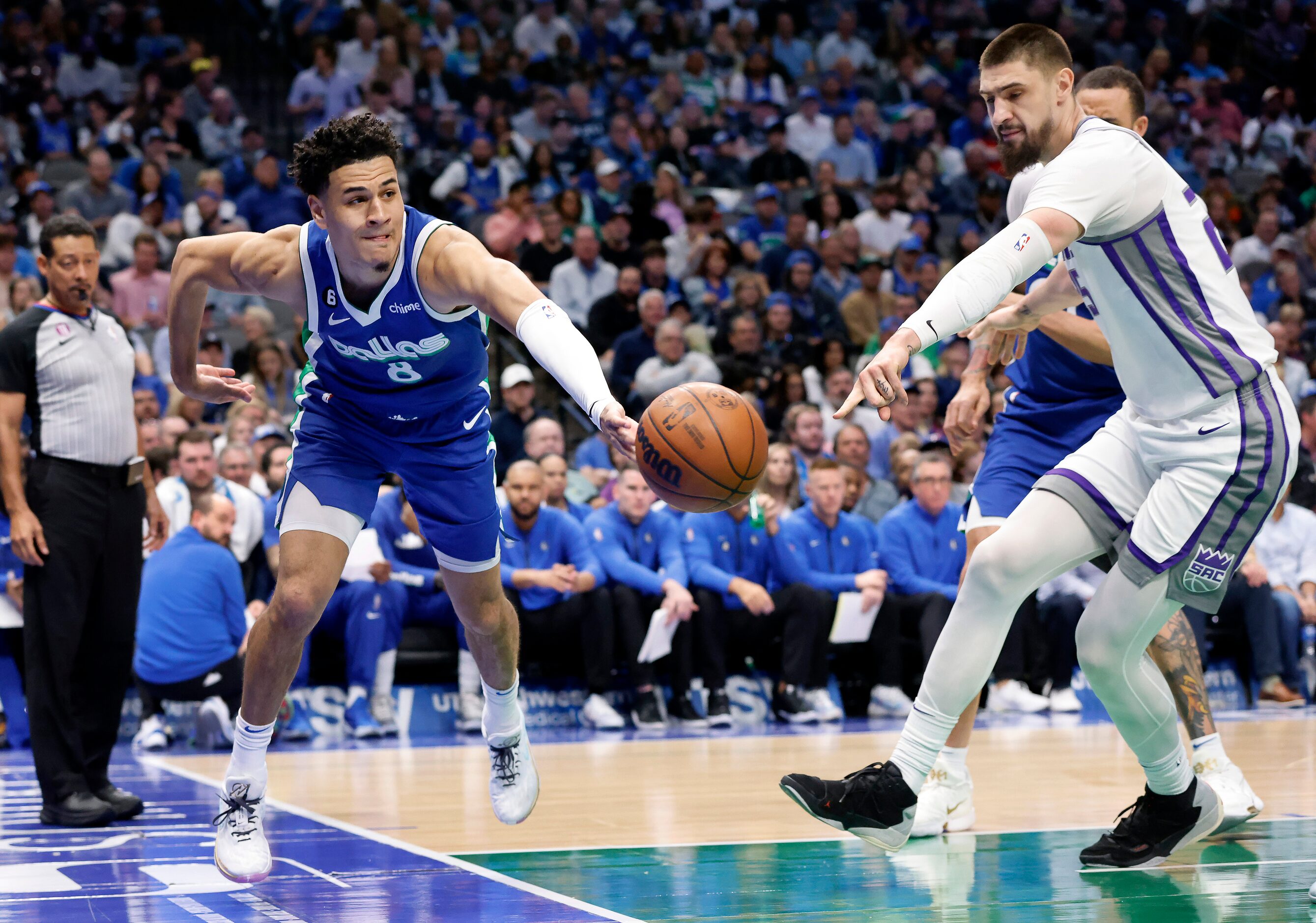 Dallas Mavericks guard Josh Green (8) tries to get a loose ball kicked out to a teammate as...