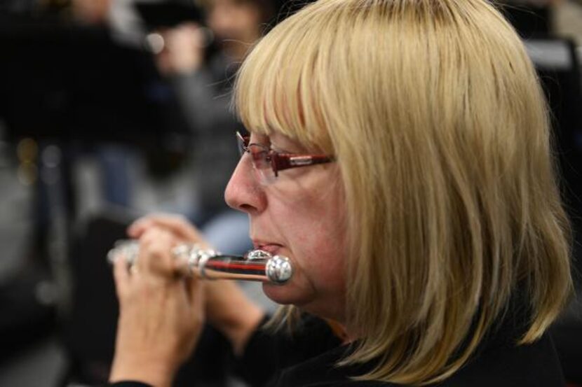 Symphony member Darlene Hunter rehearses with the group.