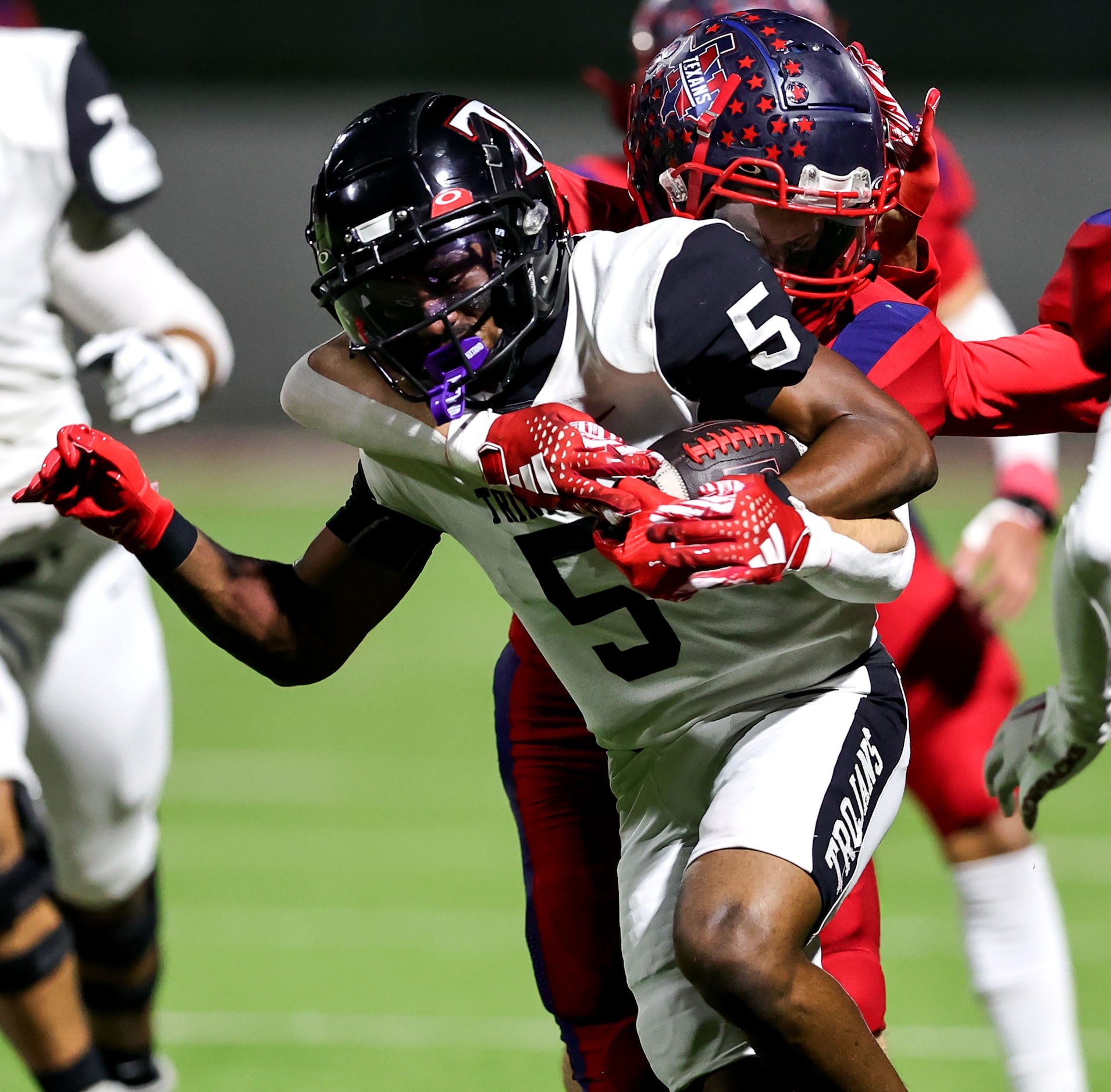 Trinity wide receiver Ethan Wright (5) is stopped by Justin Northwest defensive back Hudson...