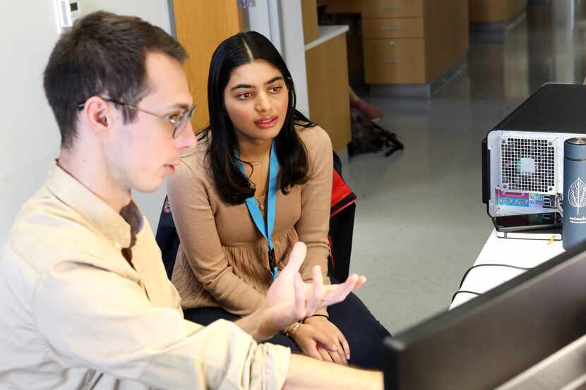 James Elder, left, and Soumya Kulkarni discuss research data at UT Southwestern Medical...