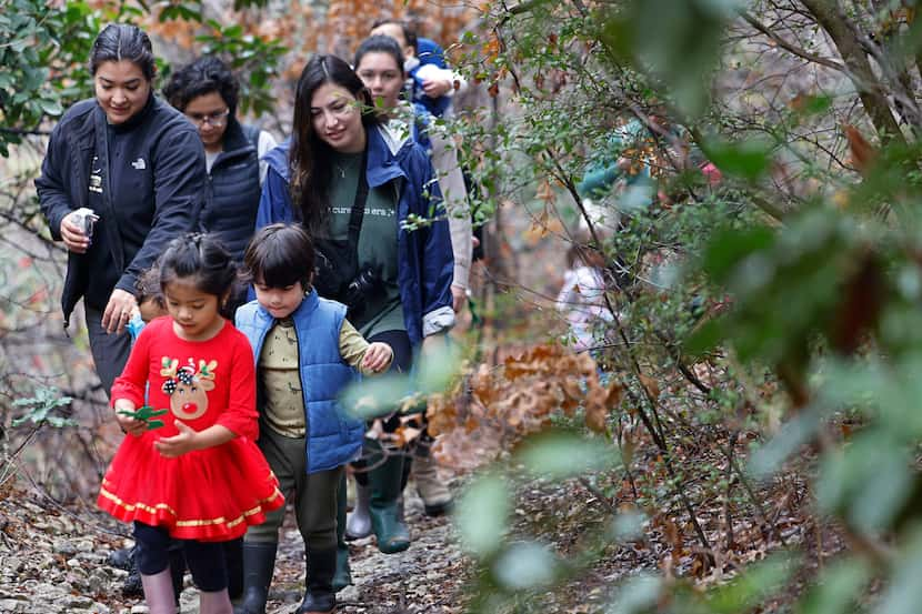 Carmelo Simental, 3, of Dallas, right, walks with Valentina De la Cruz, 4, of Dallas, red...