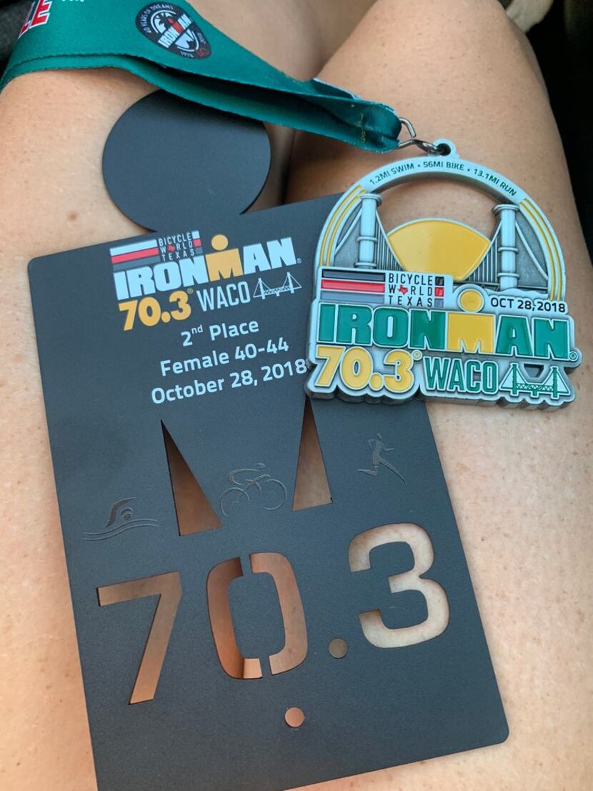 The finishers  medal and Brandi Grissom Swicegood's 2nd place trophy from Ironman 70.3 Waco.