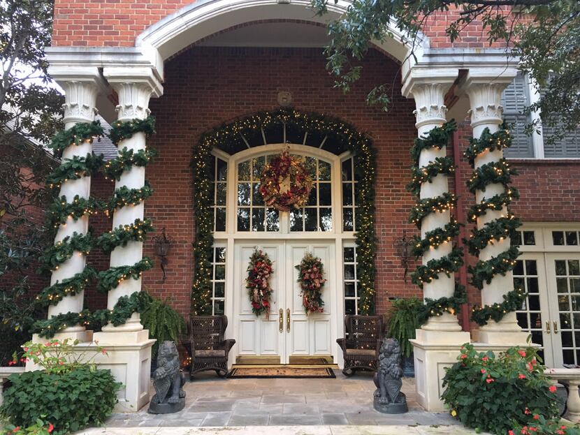 Exterior features like these tall columns wrapped in a wide garland draw attention to a...