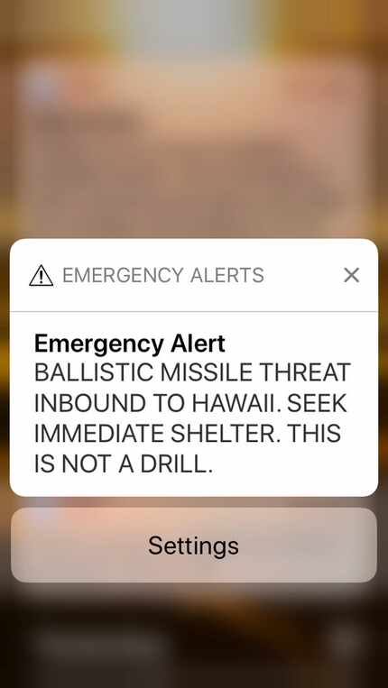 A smartphone screen capture shows a false incoming ballistic missile emergency alert sent...