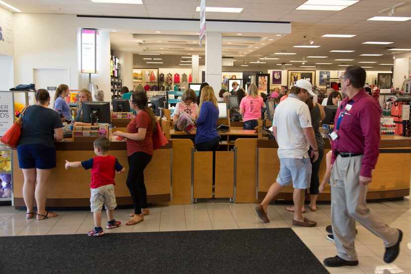 Shoppers pay for their items at the cash registers at the Kohl's store on West University...