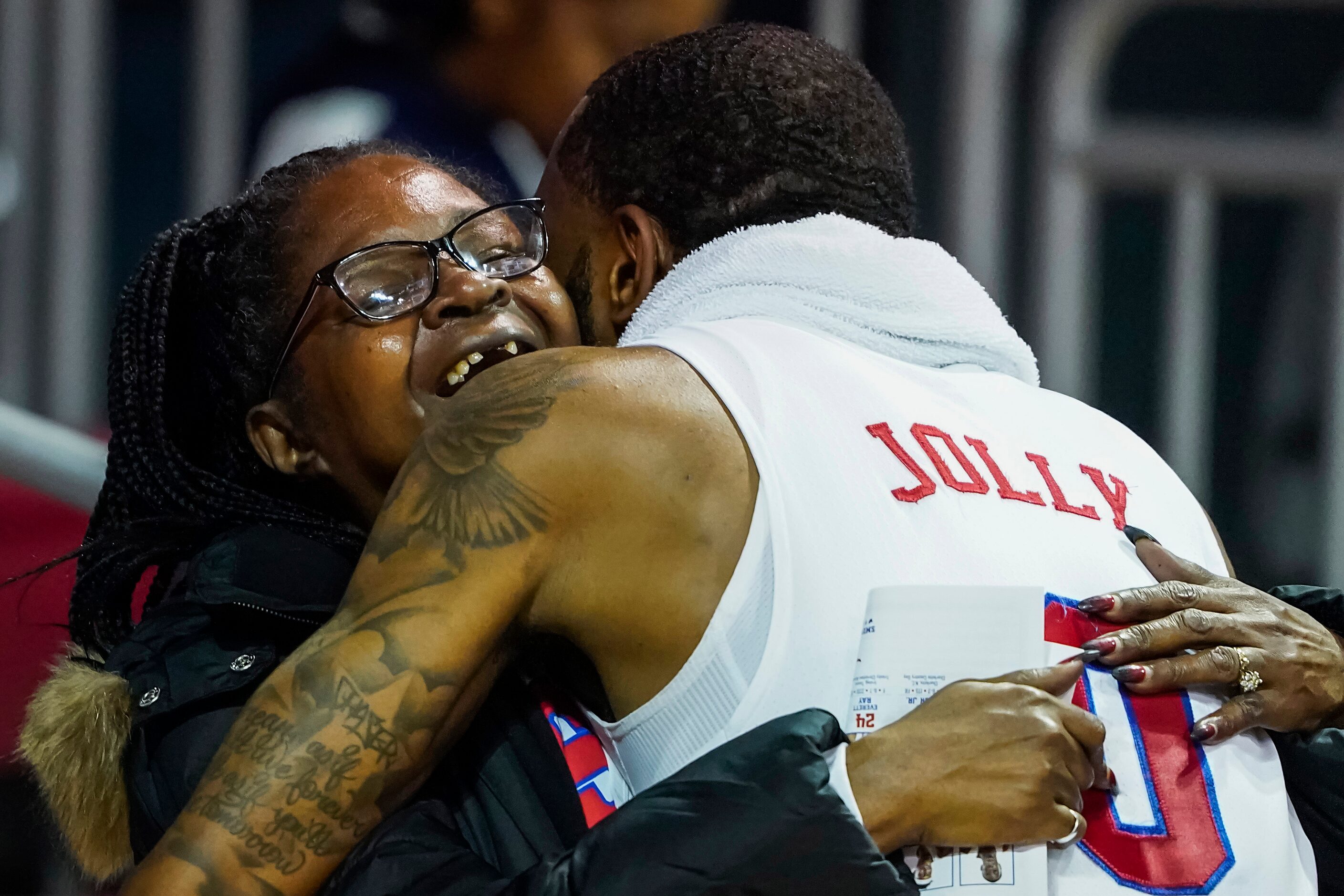 SMU guard Tyson Jolly gets a hug as he celebrates after a victory over East Carolina in an...