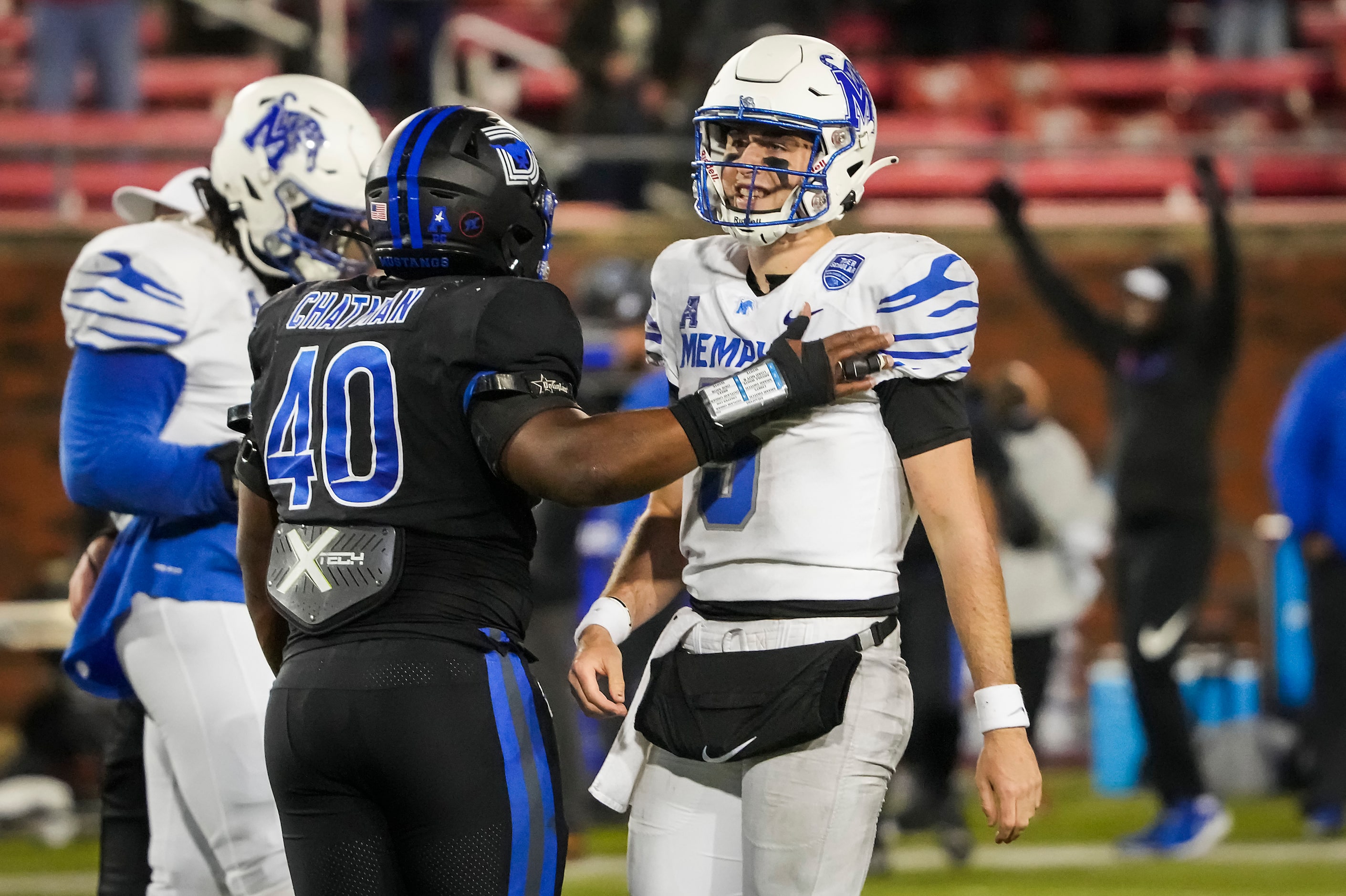 SMU defensive tackle Elijah Chatman (40) consoles Memphis quarterback Seth Henigan (5) after...