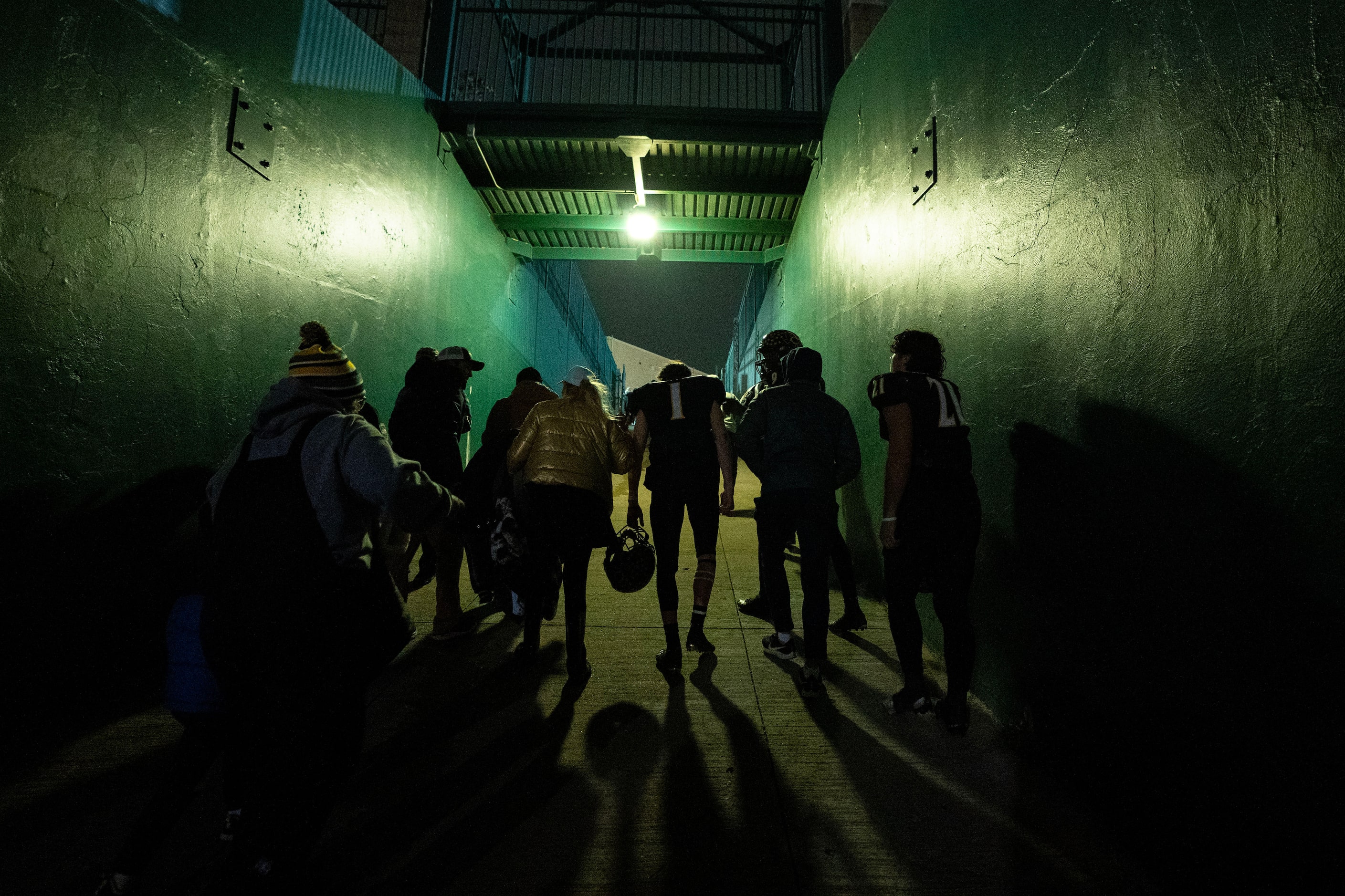 Crandall senior quarterback Luke Moffitt (1) walks up the tunnel with family, friends and...