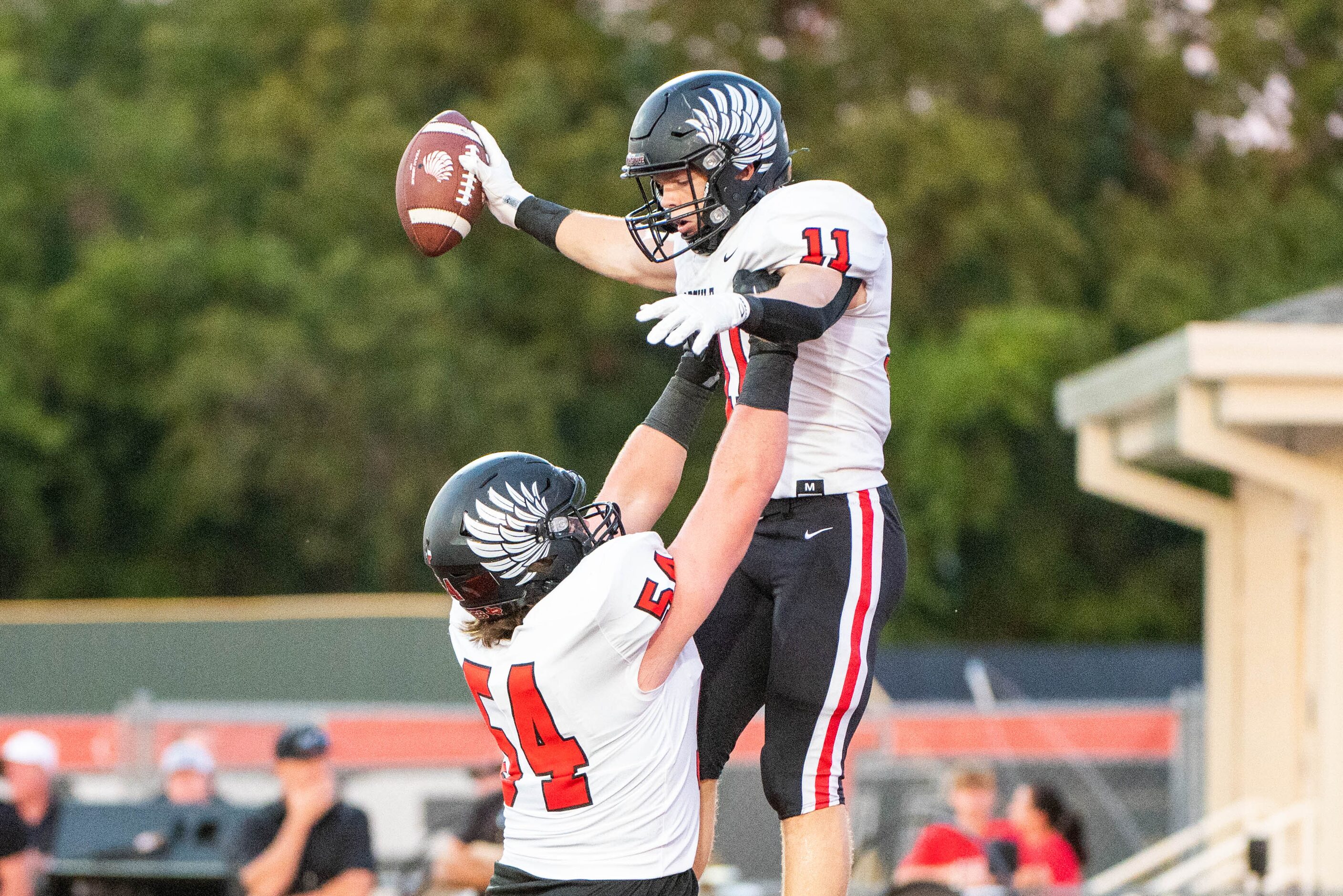 Argyle tackle Wes Tucker (54) celebrates with  RJ Bunnell (11) after Bunnell’s touchdown in...