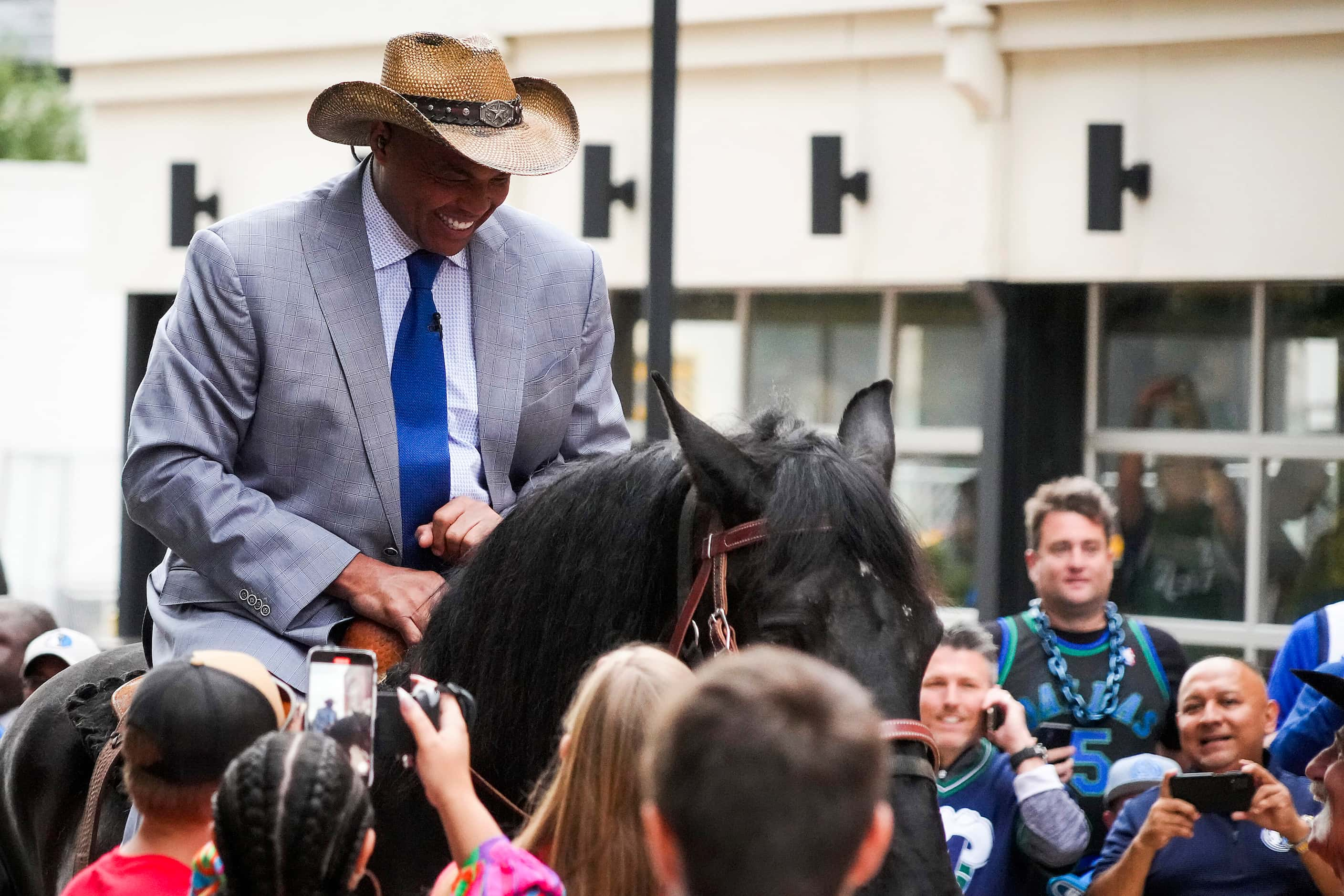 Charles Barkley arrives on horseback at the American Airlines Center as he makes his way to...