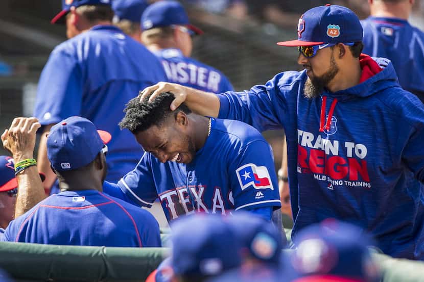Texas Rangers infielder Jurickson Profar is patted on the head by second baseman Rougned...