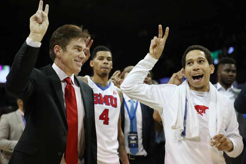 SMU interim head coach Tim Jankovich and guard Nic Moore (11) speak while participating in...