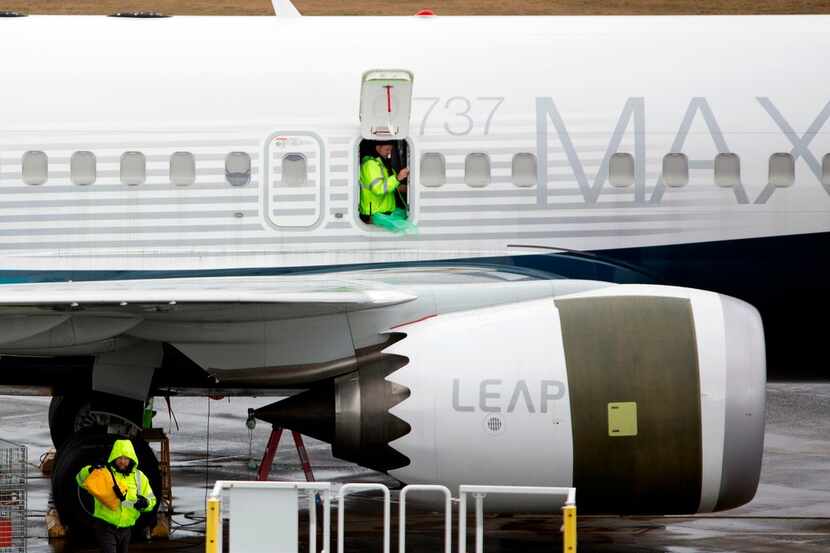 (FILES) In this file photo taken on March 12, 2019, workers are pictured next to a Boeing...