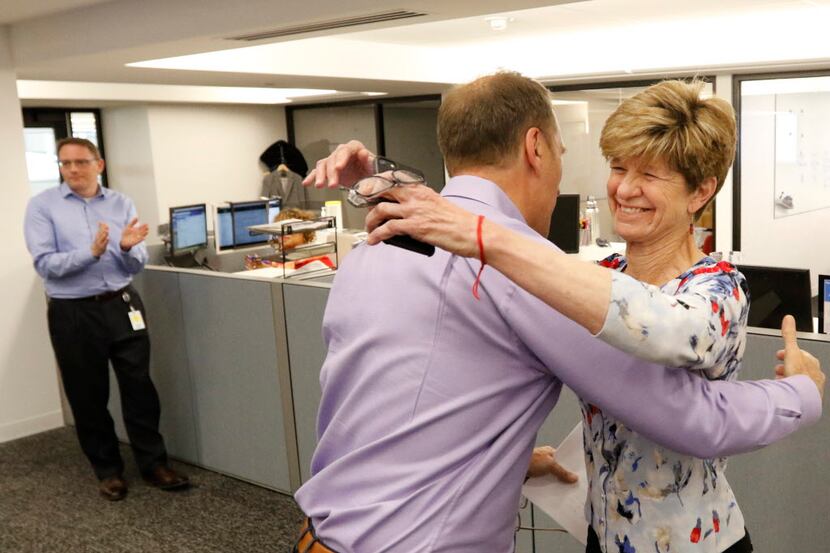 Dallas Morning News editor Mike Wilson hugs 2018 Pulitzer Prize editorial writing finalist...