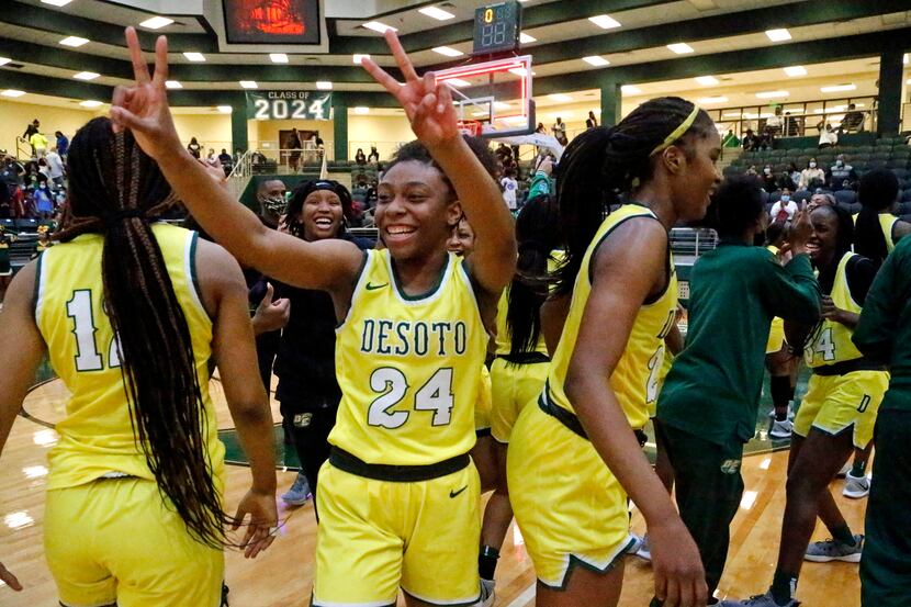 DeSoto High School forward Ari' Yanna HInes (24) celebrates the victory after the game as...