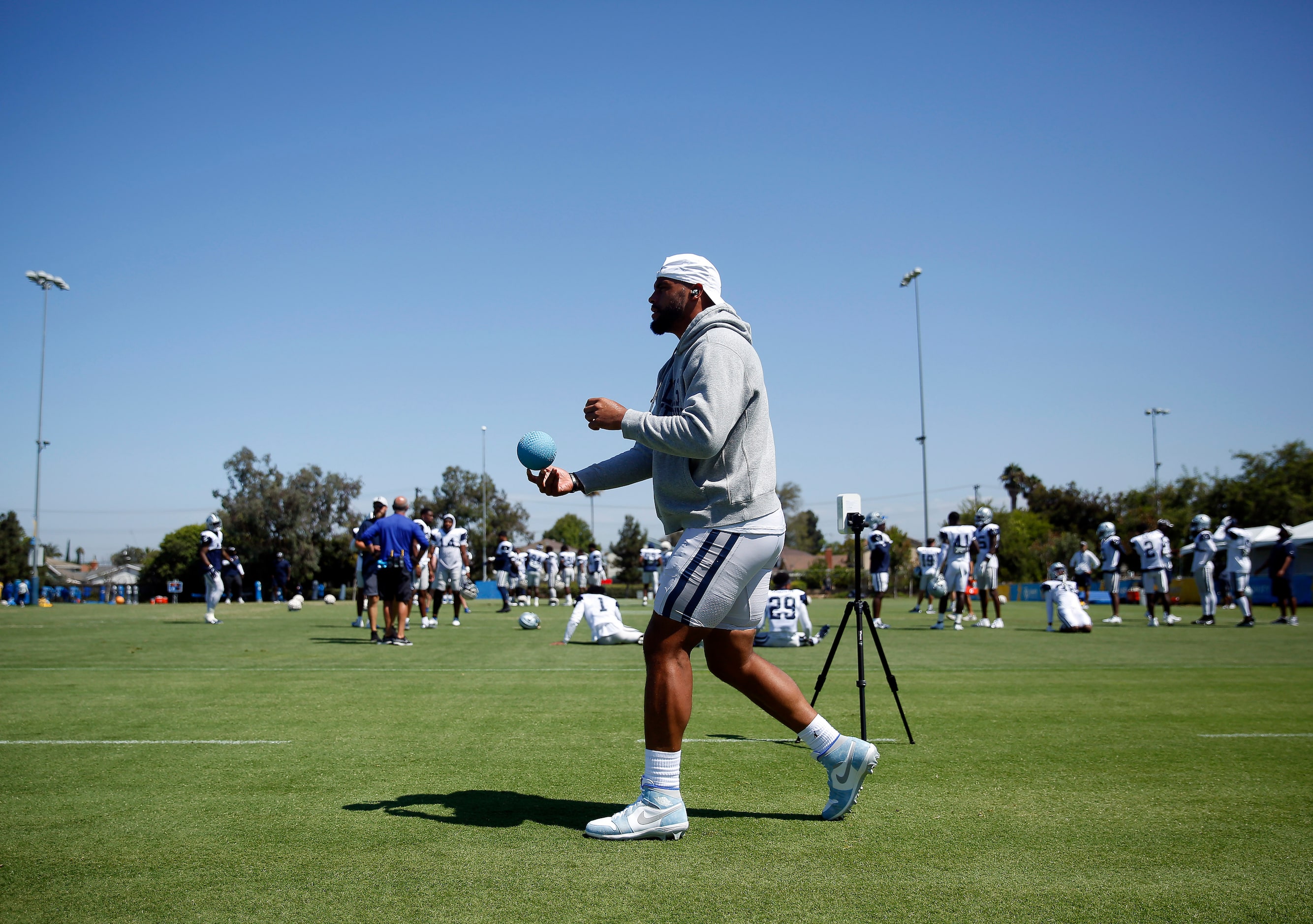 Dallas Cowboys quarterback Dak Prescott stretches before a joint practice with the Los...