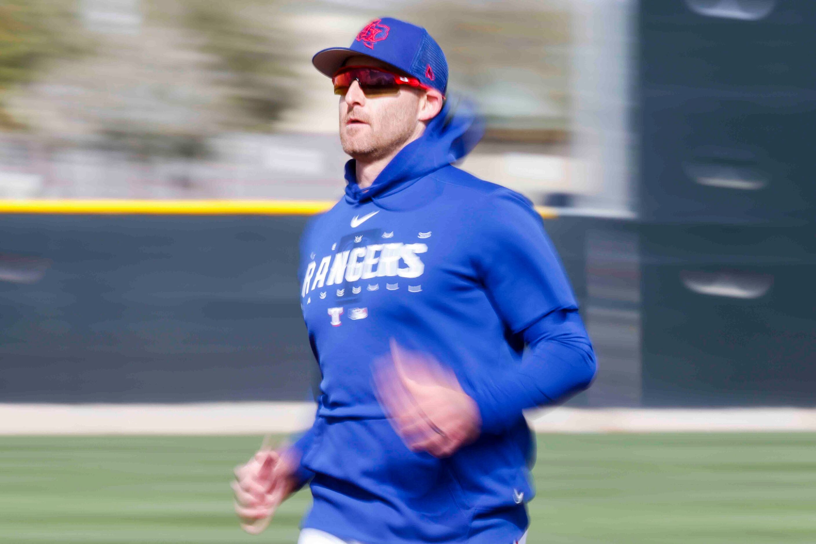 Texas Rangers outfielder Brad Miller runs between bases during a spring training workout at...