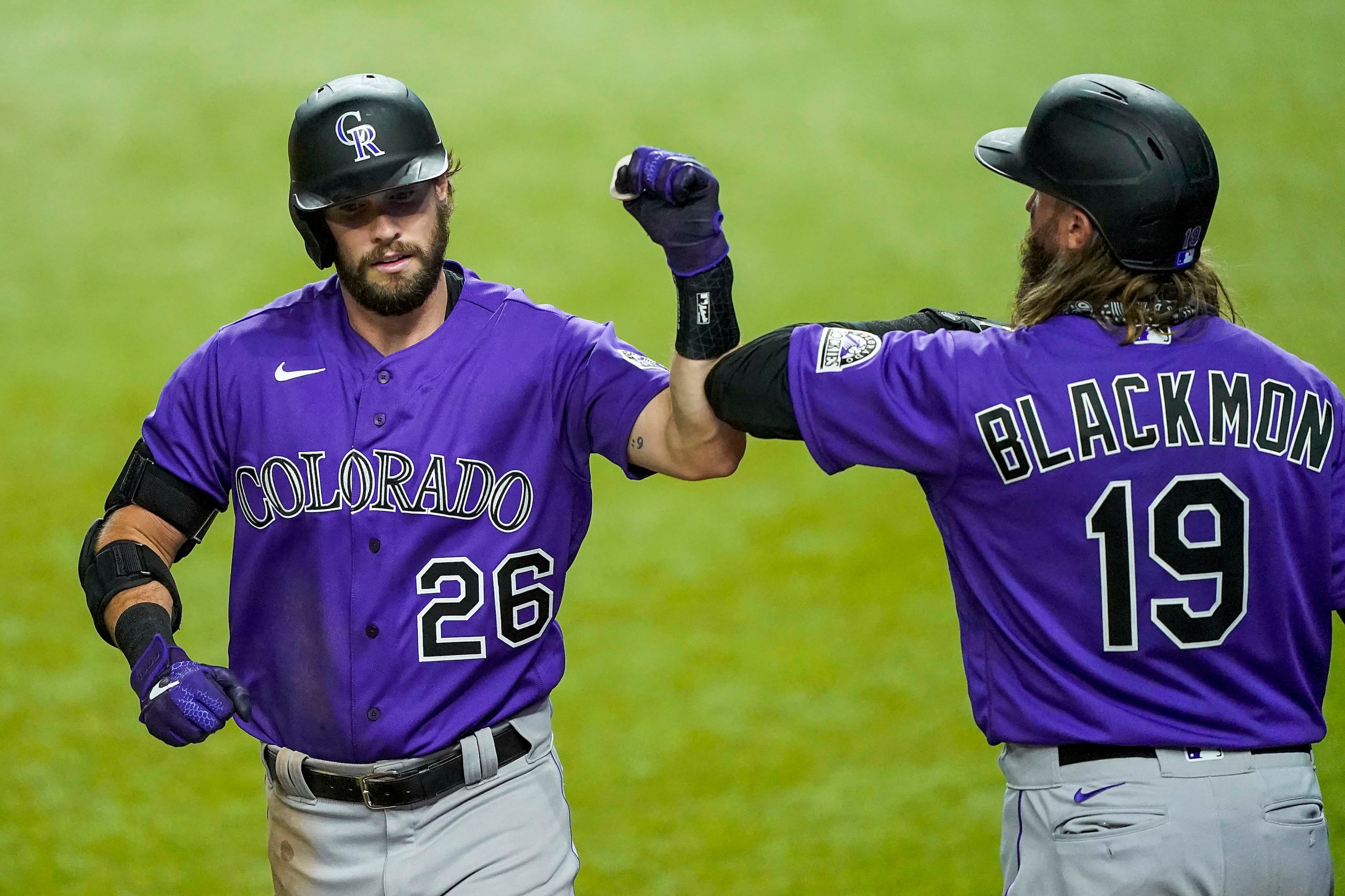 Colorado Rockies outfielder David Dahl celebrates with Charlie Blackmon after hitting a...