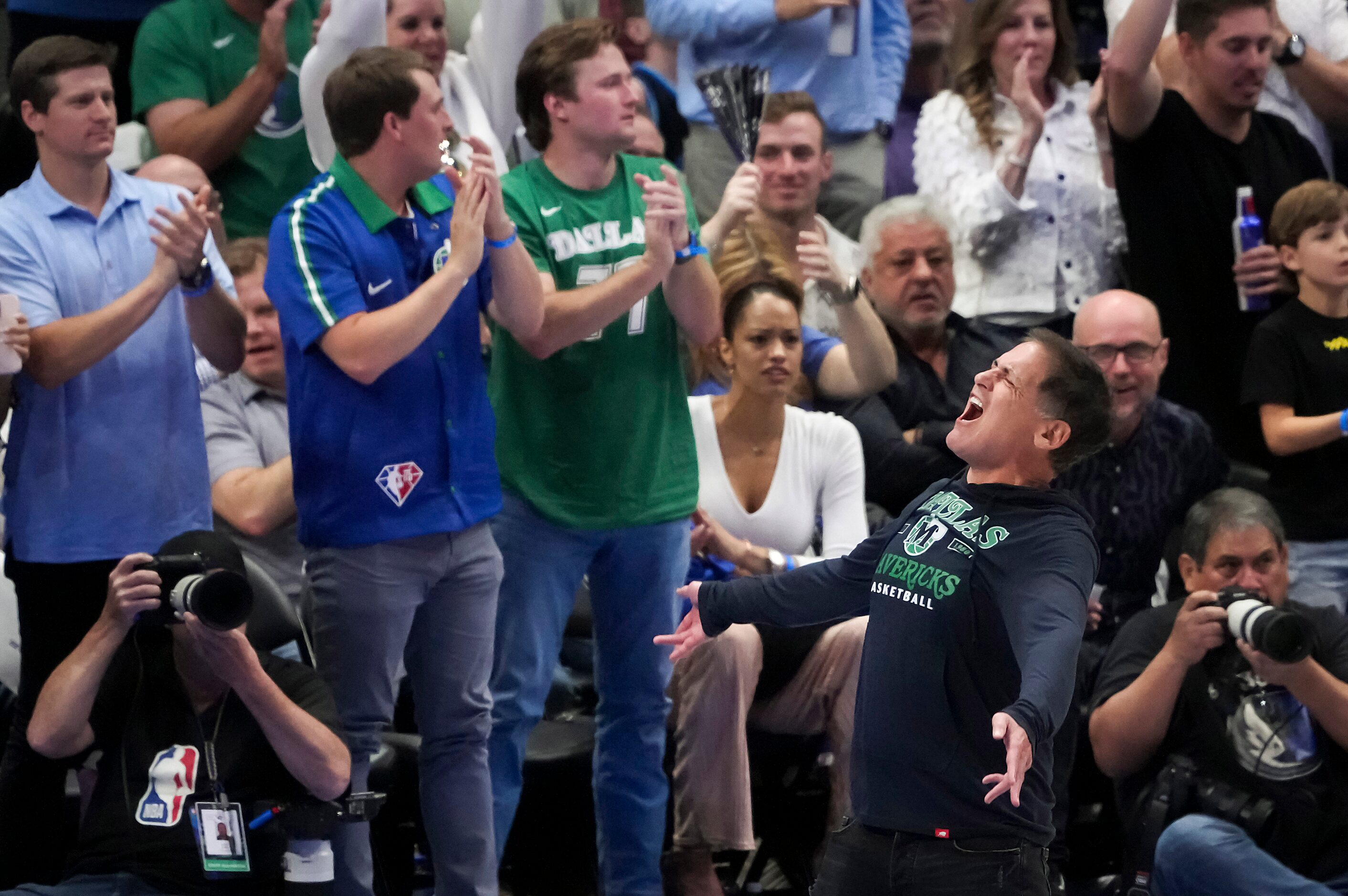 Dallas Mavericks owner Mark Cuban celebrates during the second quarter in Game 3 of an NBA...