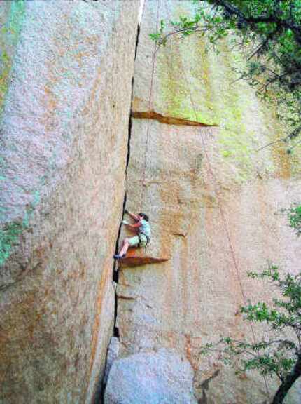 Cheryl Chunco makes her way up the wall called Fear of Flying at Enchanted Rock State...