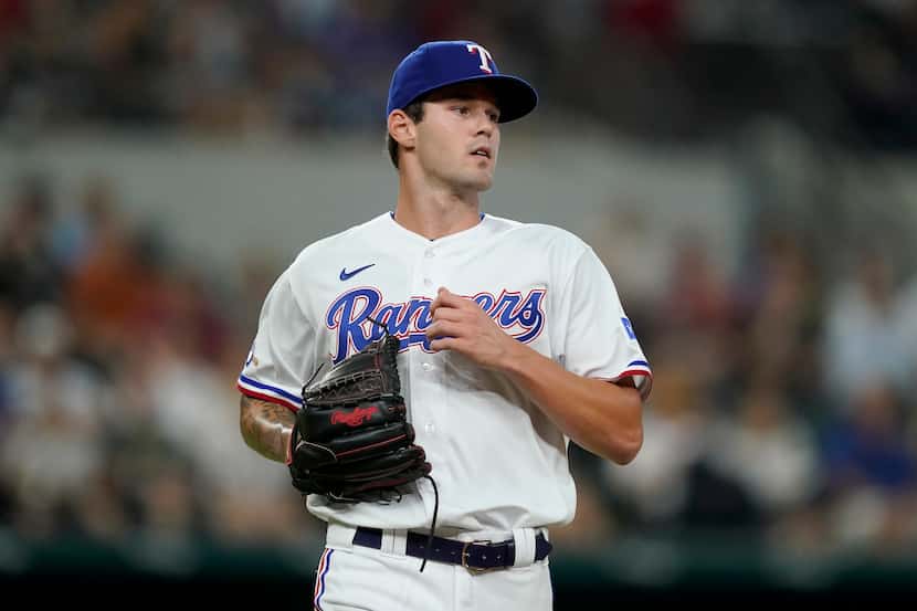 Texas Rangers pitcher Cole Ragans jogs to the dugout after throwing to the Chicago White Sox...