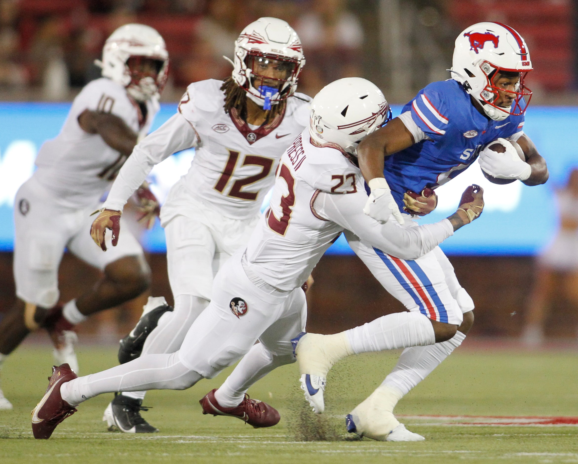 SMU Mustangs receiver Moochie Dixon (5), right, tacks on extra yardage after a second half...