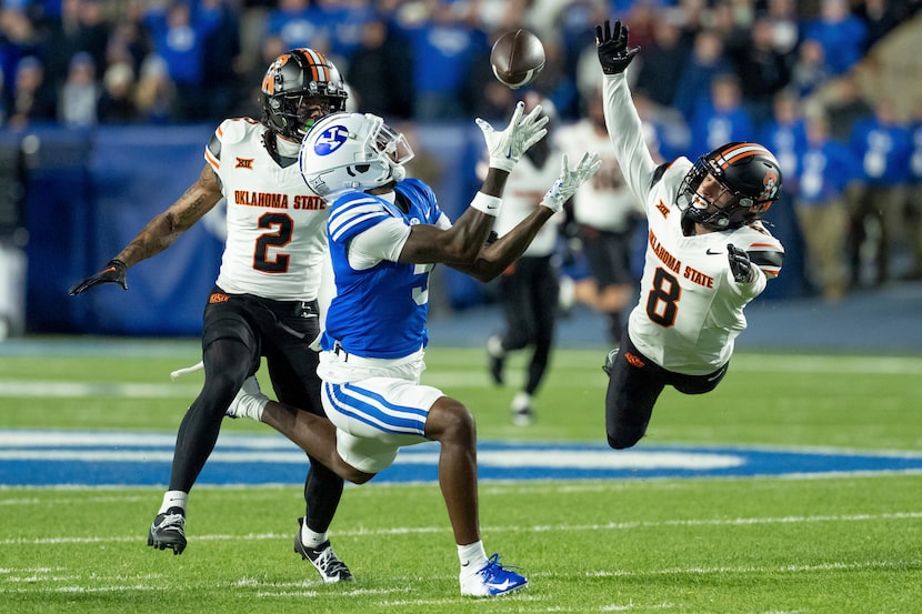 BYU wide receiver Darius Lassiter makes a catch ahead of Oklahoma State cornerback Korie...