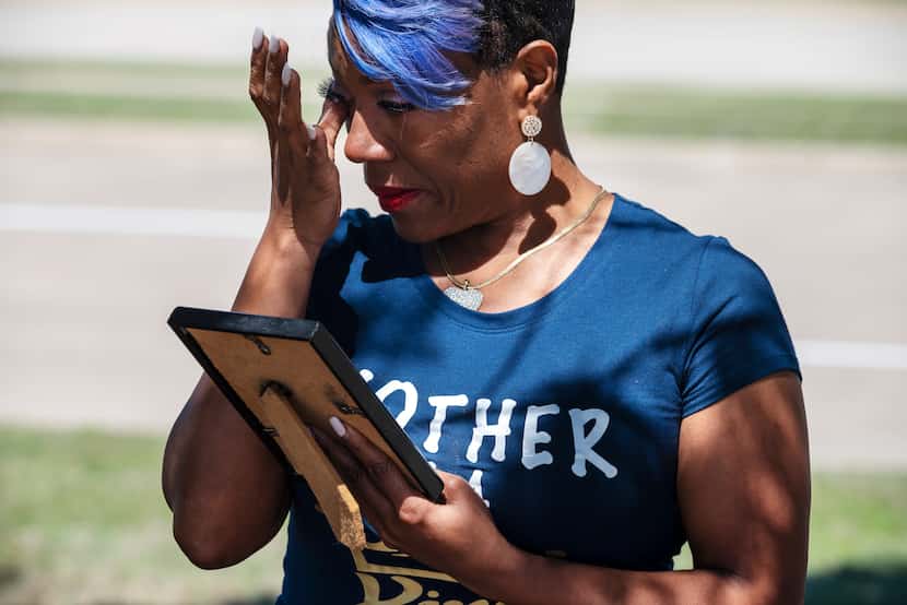 Donna Fields, 47, wipes away tears while looking at a photo of her son Marcus Bell Jr., when...