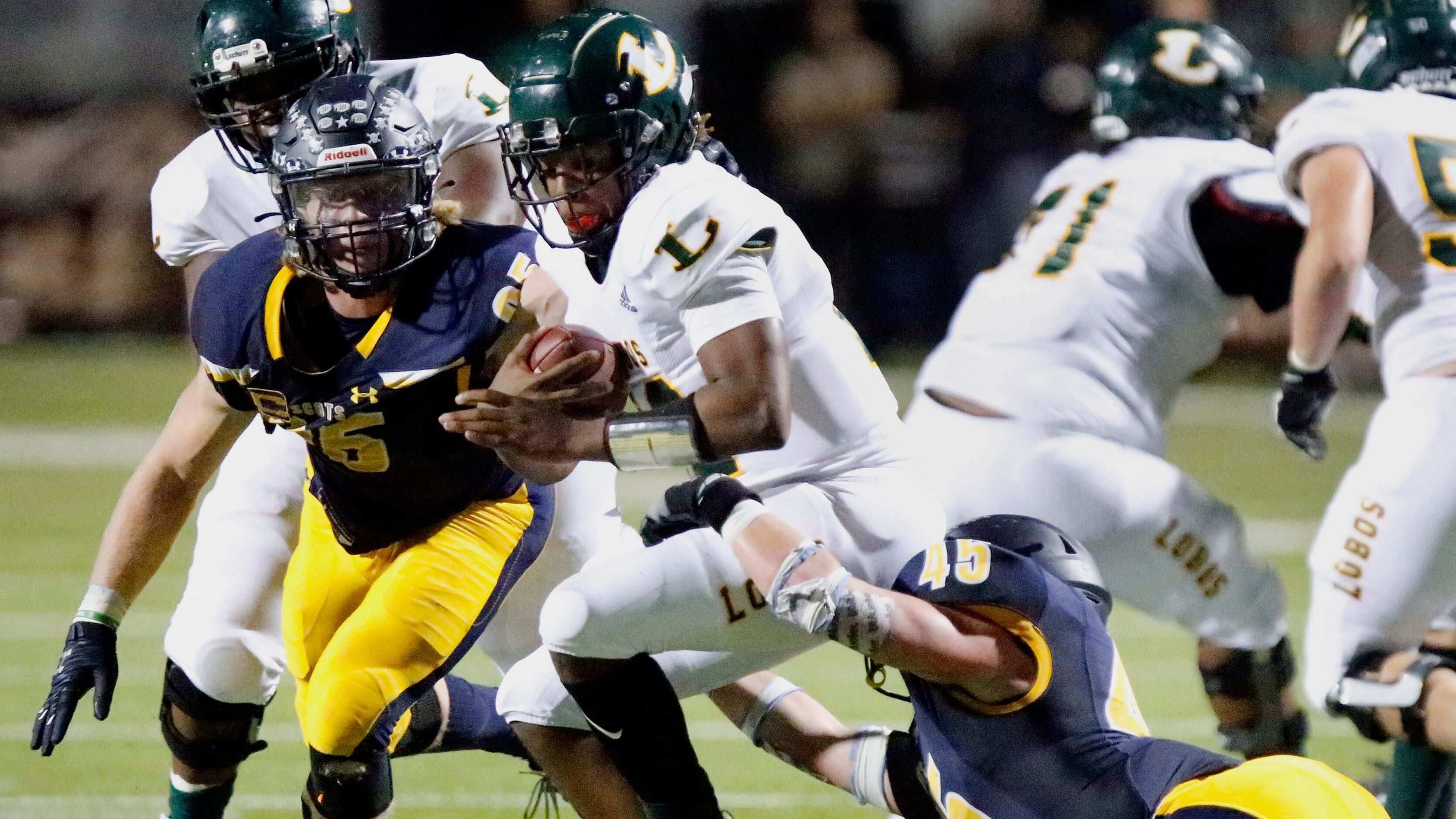 Longview High School quarterback Jordan Allen(12) is taken down by Highland Park High School...