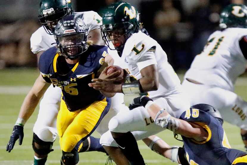 Longview High School quarterback Jordan Allen(12) is taken down by Highland Park High School...