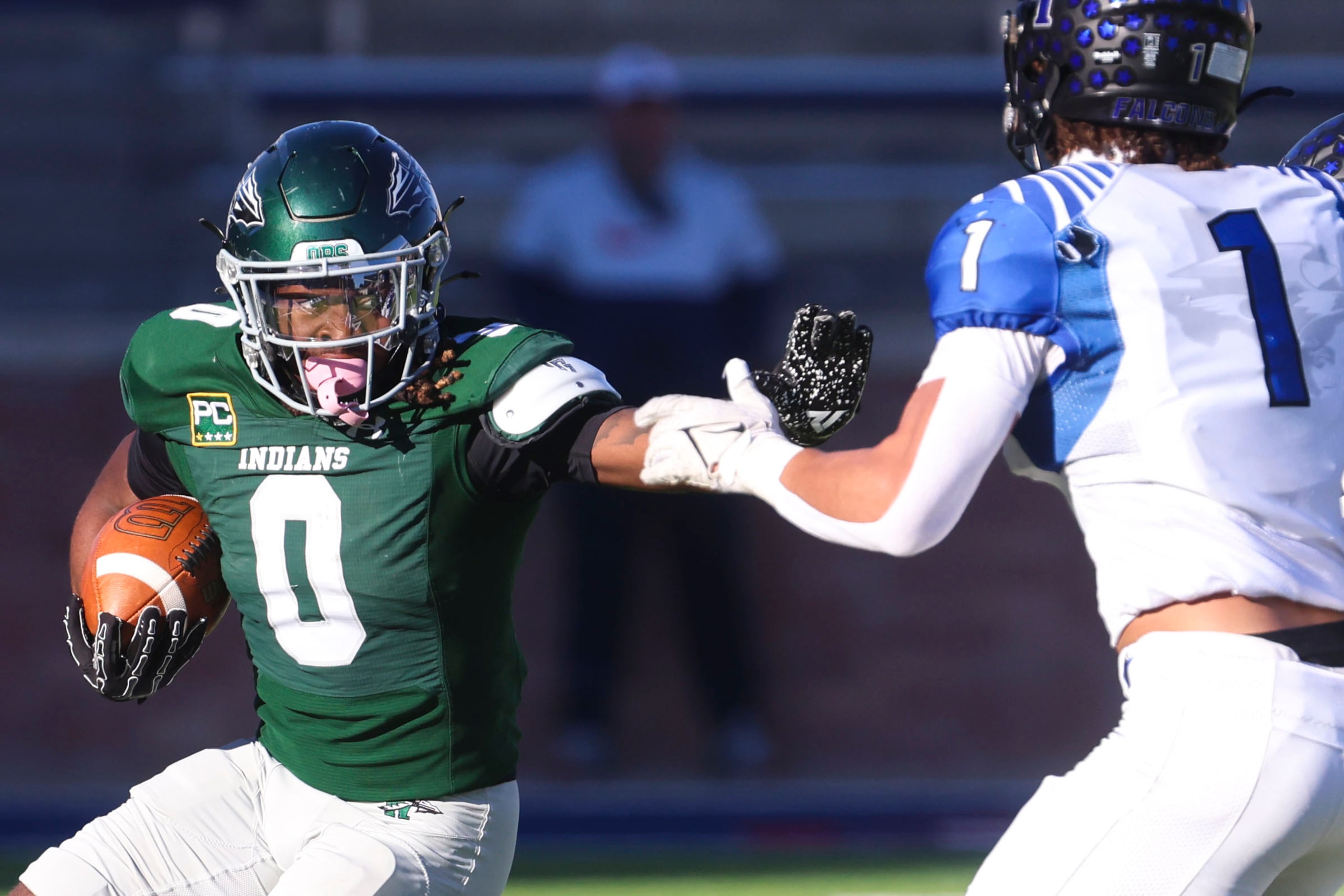 Waxahachie High’s Bryson Linnear (0) reaches to stiff arm North Forney’s Caleb Holt during...