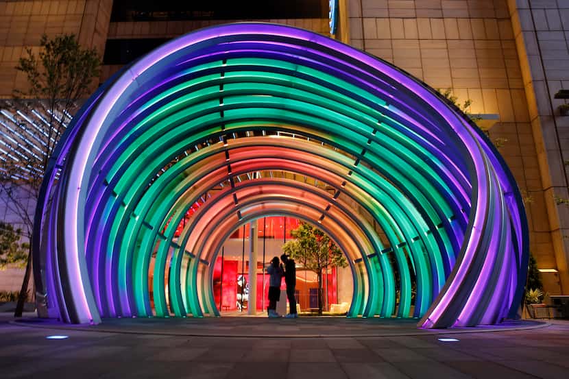 Kids hang out in the 30 ft. tall LED-lit Globe in the new AT&T Discovery District in...