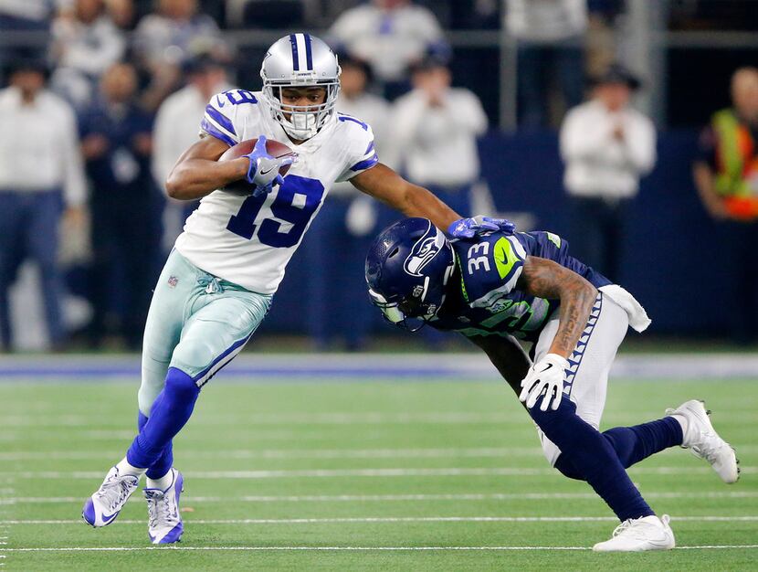 FILE - Cowboys receiver Amari Cooper (19) tries to avoid a tackle by Seattle Seahawks safety...