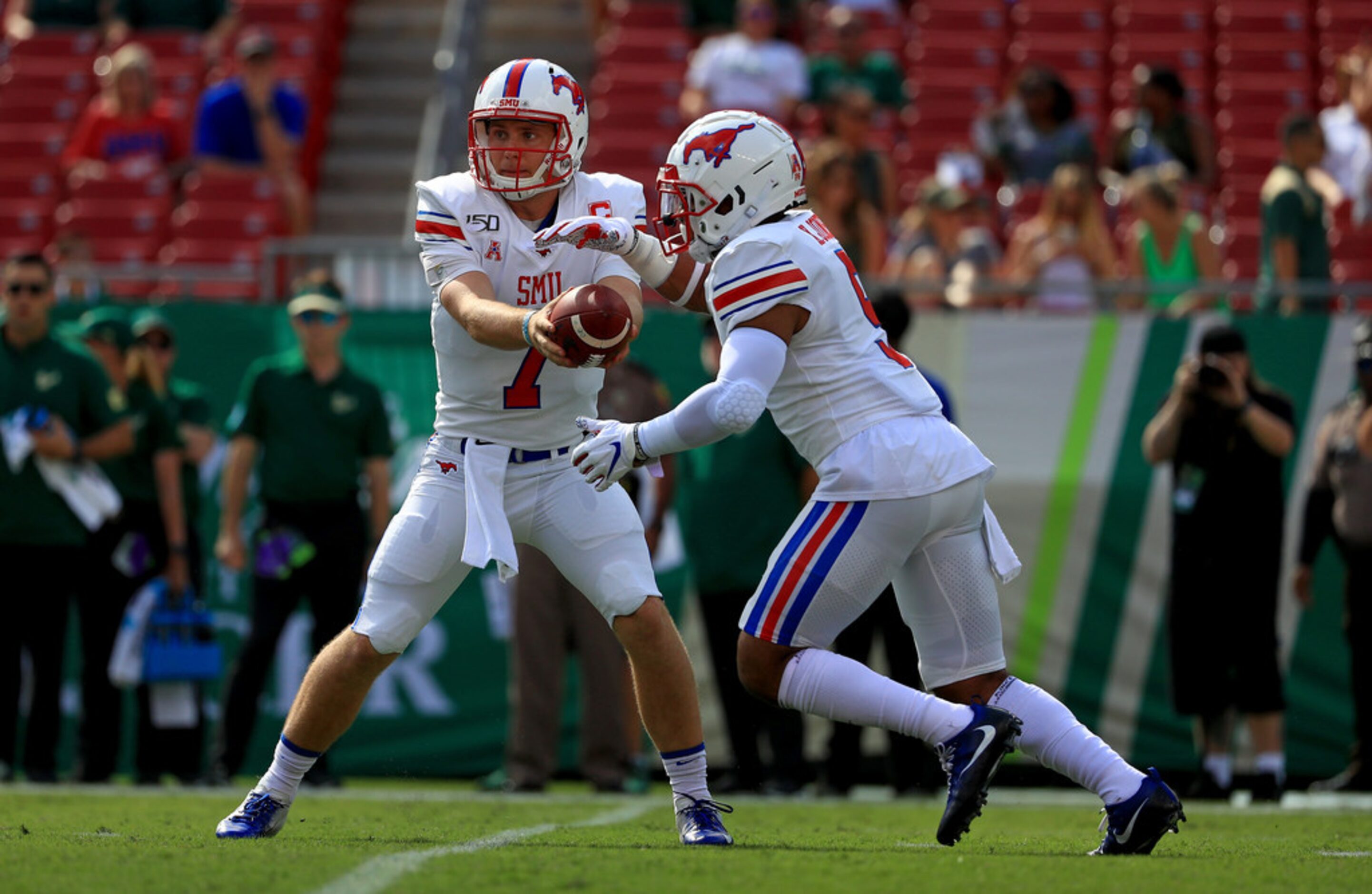 TAMPA, FLORIDA - SEPTEMBER 28: Shane Buechele #7 of the Southern Methodist Mustangs hands...