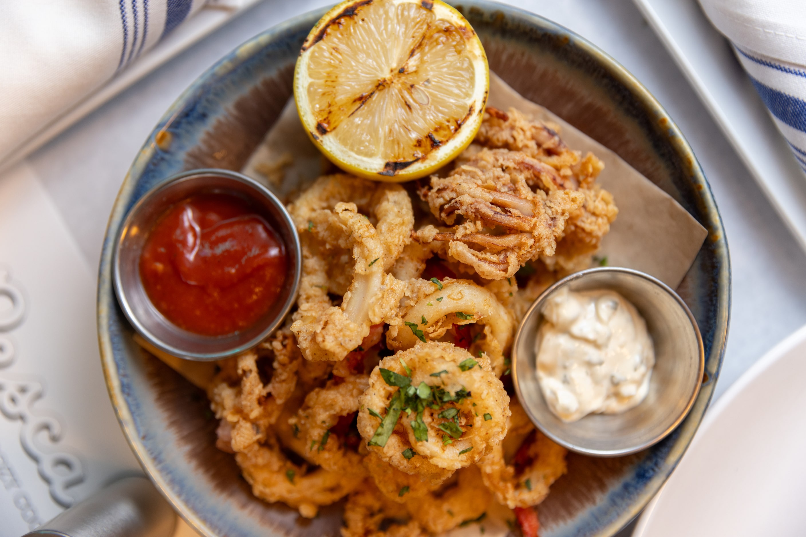 Fried calamari with serrano aioli and spicy secret sauce is available at Pesca on Dec. 13,...