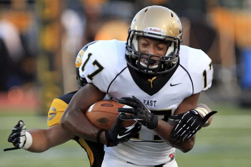 Plano East's Shawn Franks (17) advances a reception during the first quarter of a high...