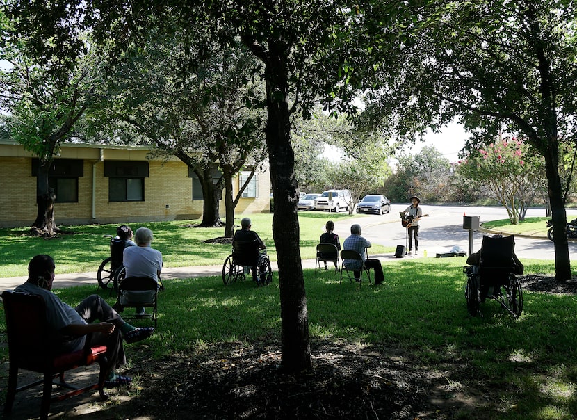 Guitarist Paul Demer performs in a small outdoor concert for the residents of Ashford Hall...