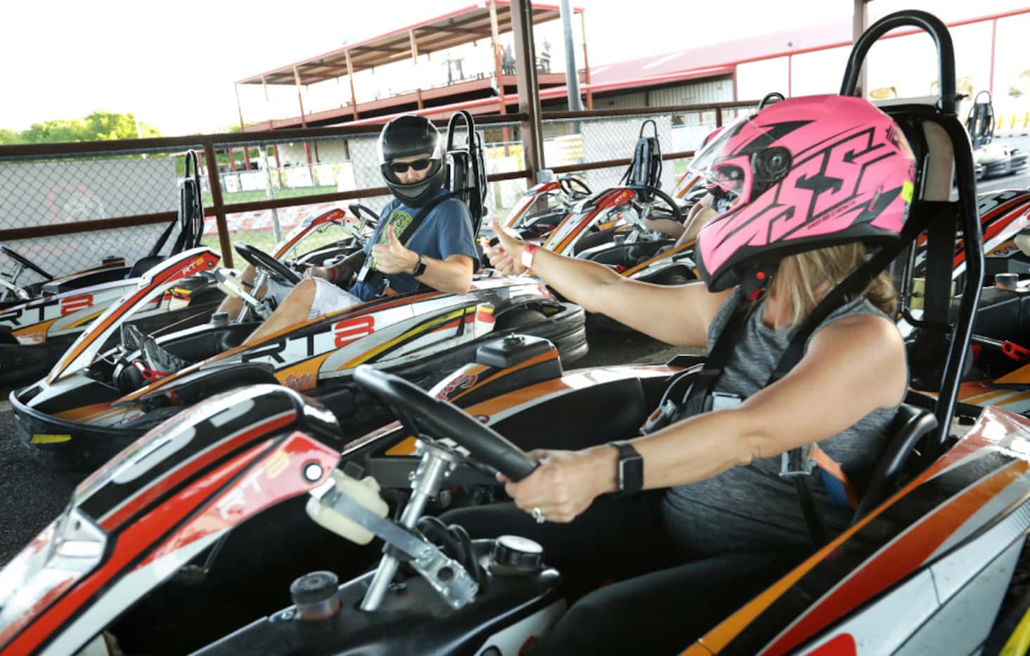 Nathan Majors, left, and Michelle Majors give a thumbs up as they prepare to race go-carts...