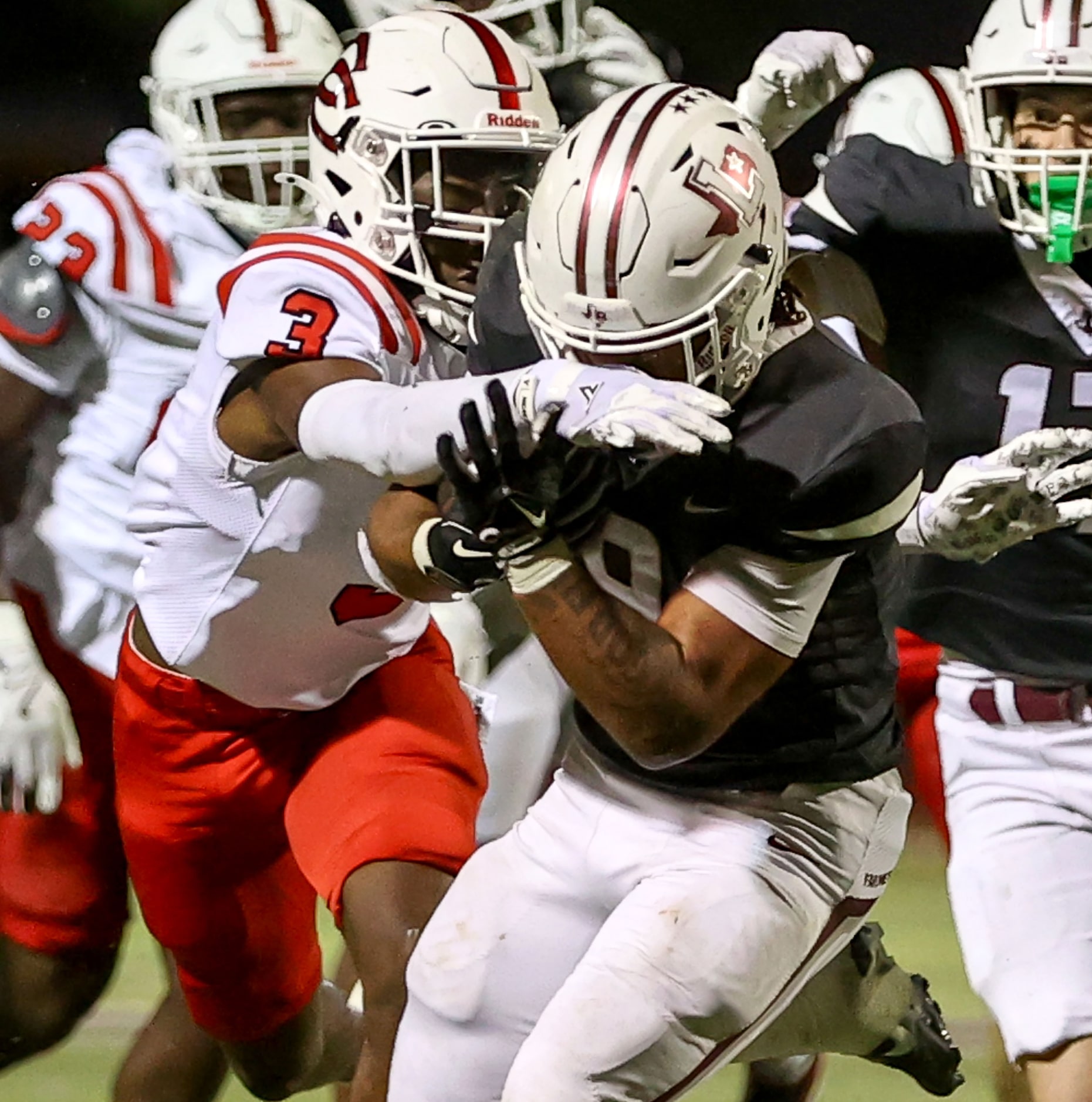 Lewisville running back Tenel Hill (9) draws a facemask against Coppell cornerback Seth...