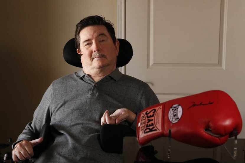 Kent Waldrep poses for a portrait with a boxing glove signed by Muhammad Ali at his home in...
