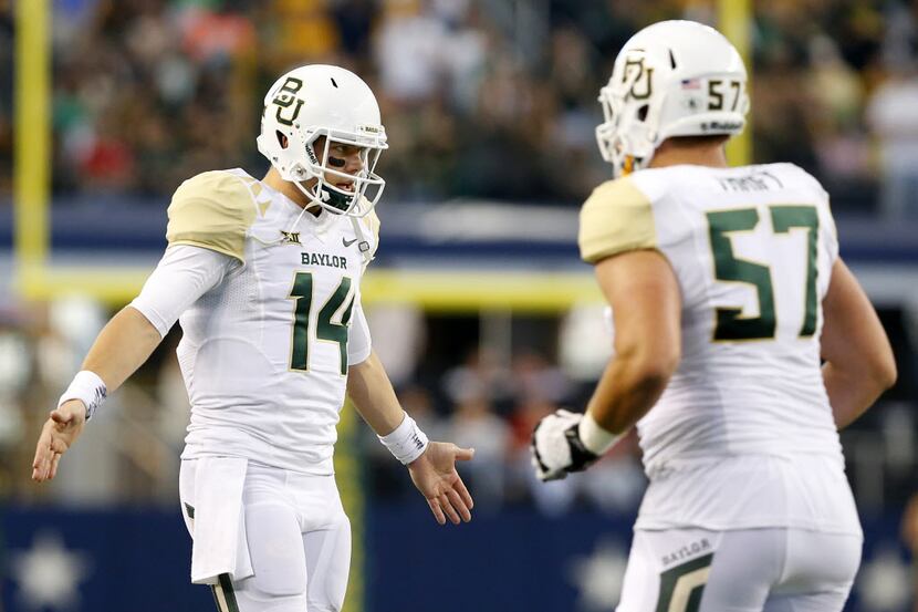 Baylor Bears quarterback Bryce Petty (14) applauds his teammates after a touchdown in the...