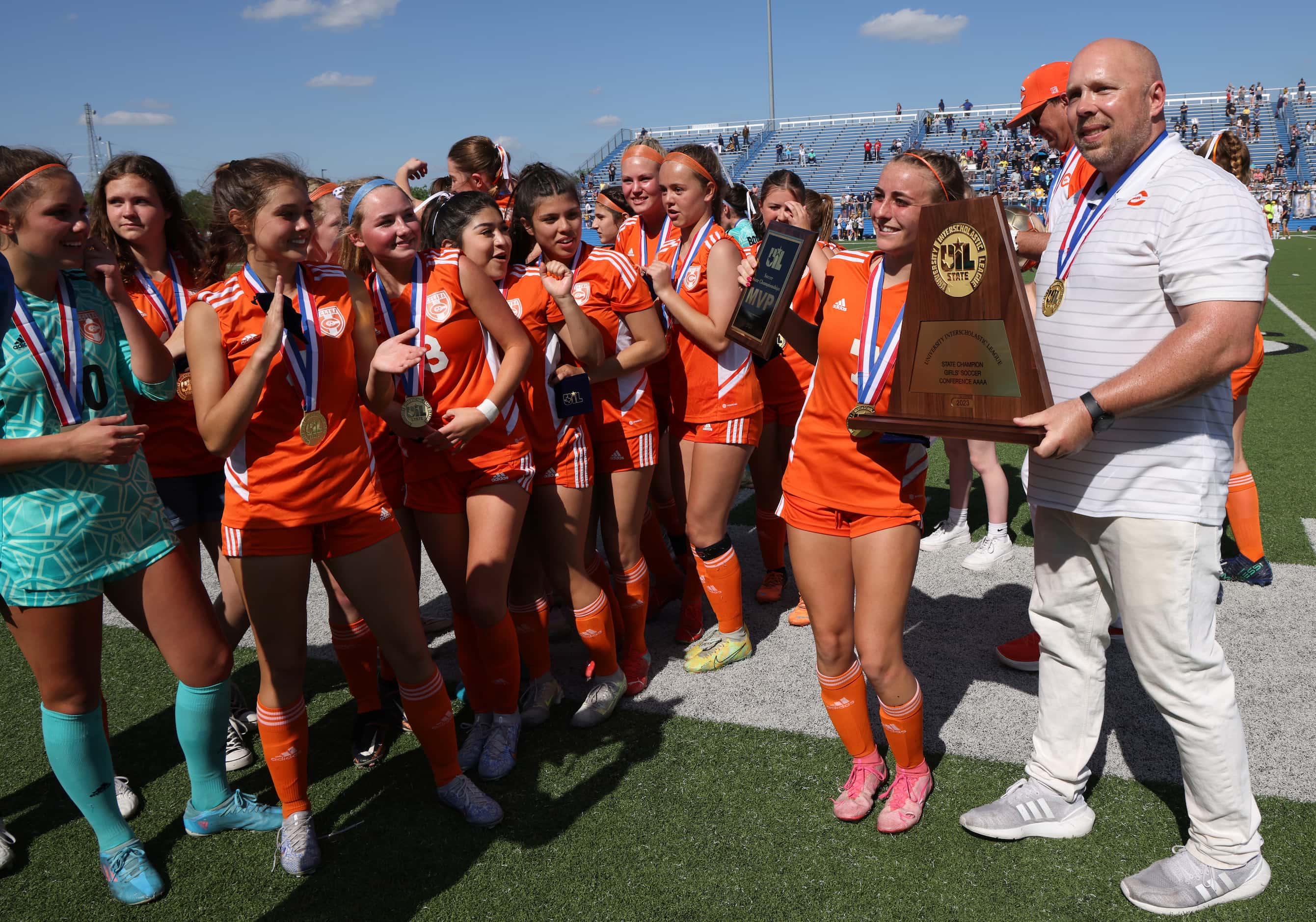 Celina head coach Alexander Adams poses with MVP Lexie Tuite (7) and the state championship...