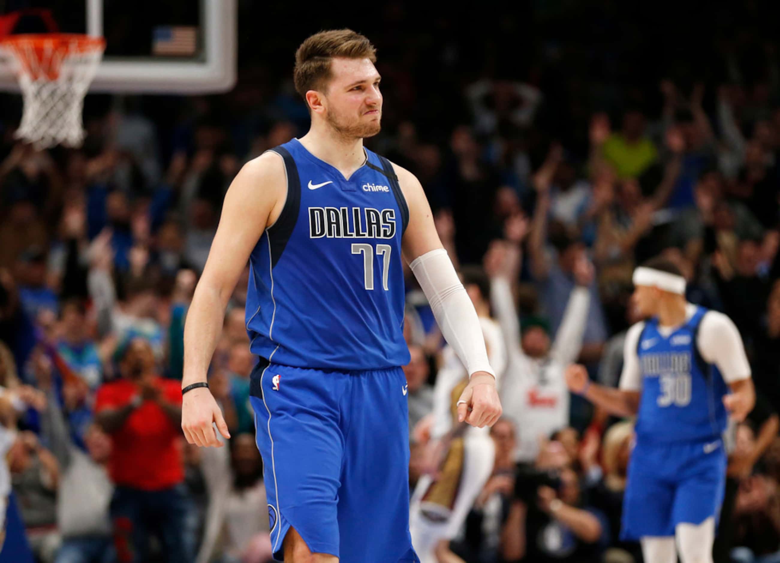 Dallas Mavericks guard Luka Doncic (77) smiles after making a three pointer late in overtime...