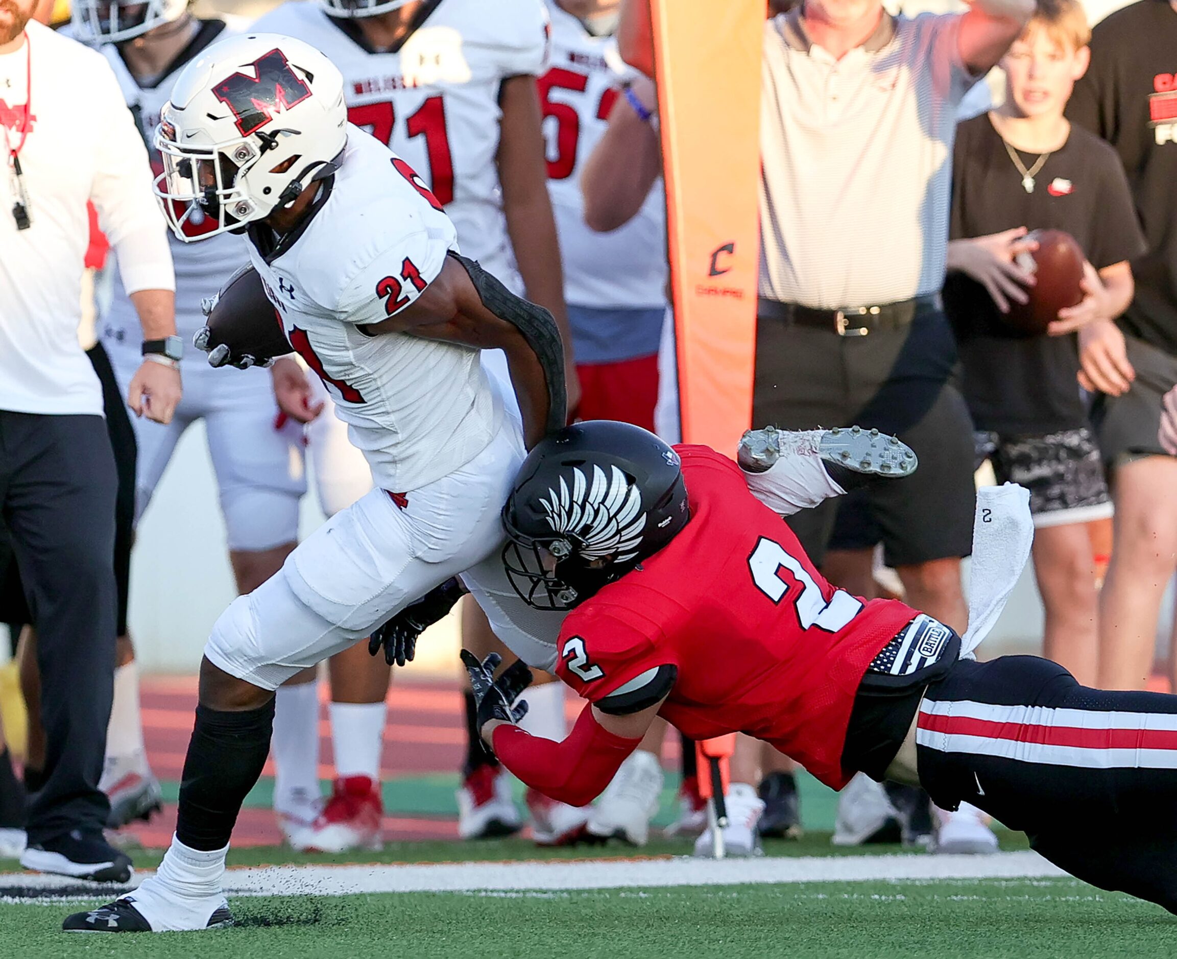 Melissa running back Nathan Adejokun (21) tries to break free from Argyle's Dax Horany (2)...