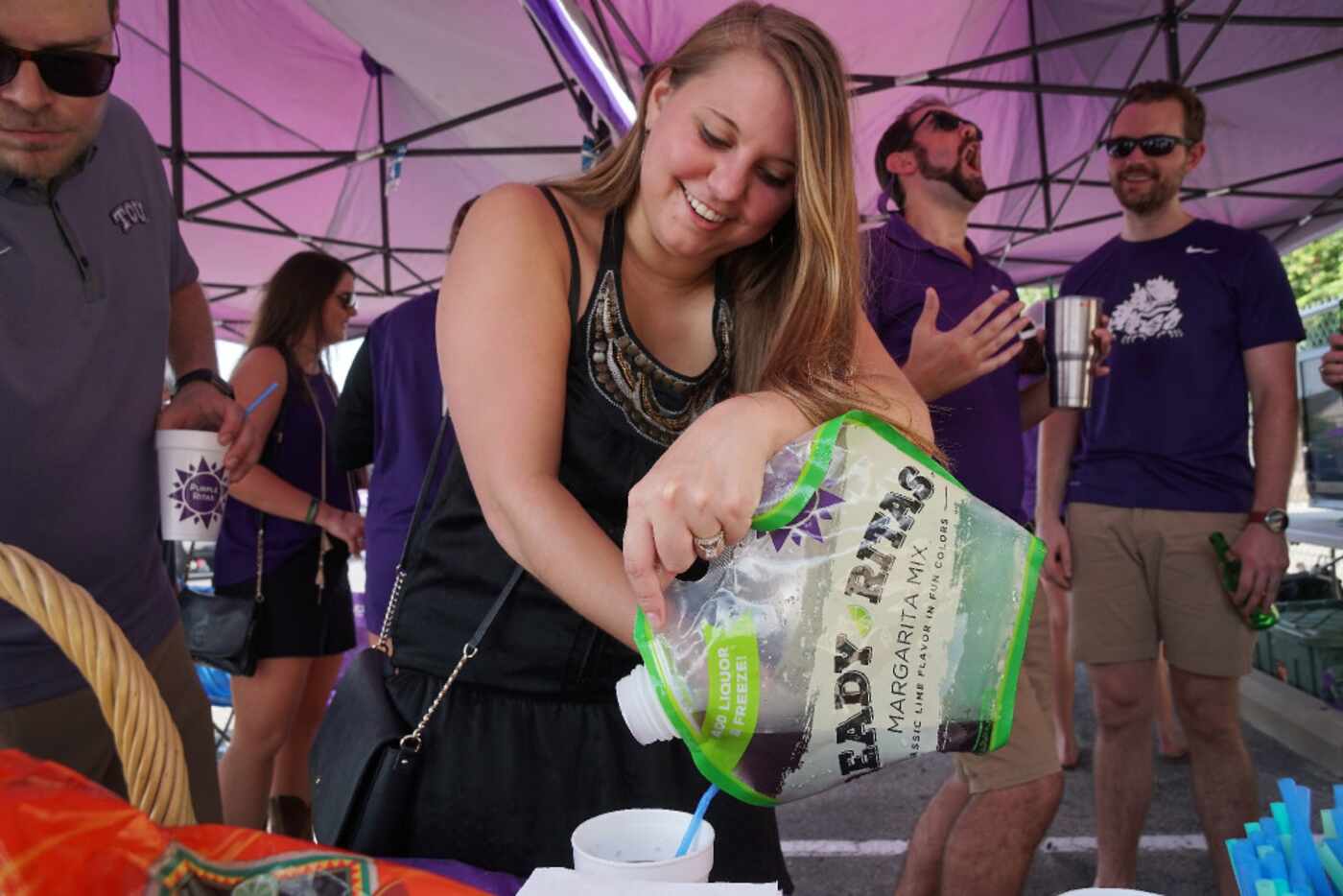 Becky Blake pours a "Ready Ritas" margarita while tailgating with friends at a TCU football...