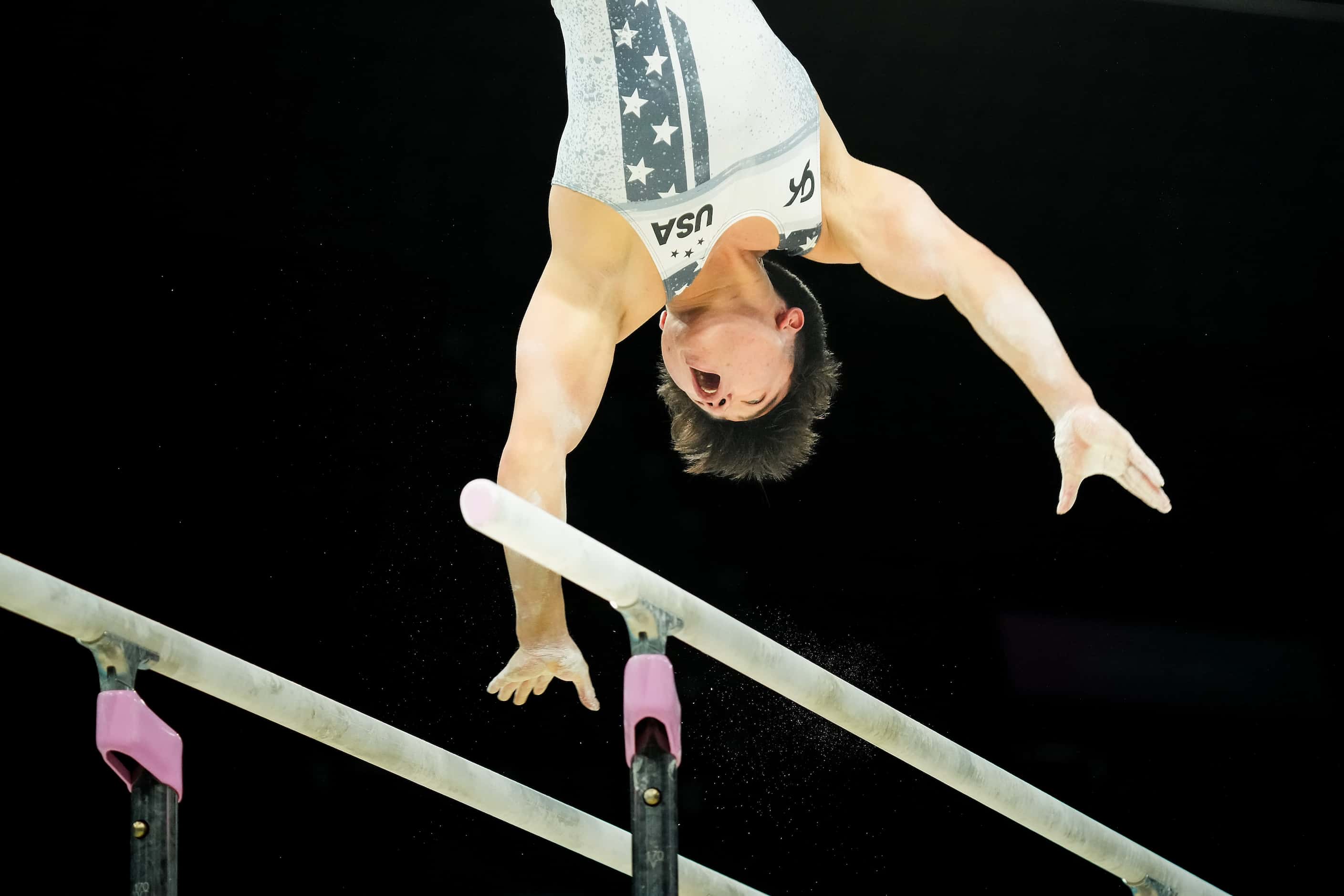 Asher Hong of the United States works on the parallel bars during gymnastics podium training...