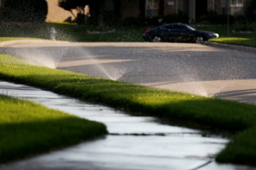 Sprinklers along Sagewood Court in Plano, one of the cities in the North Texas Municipal...