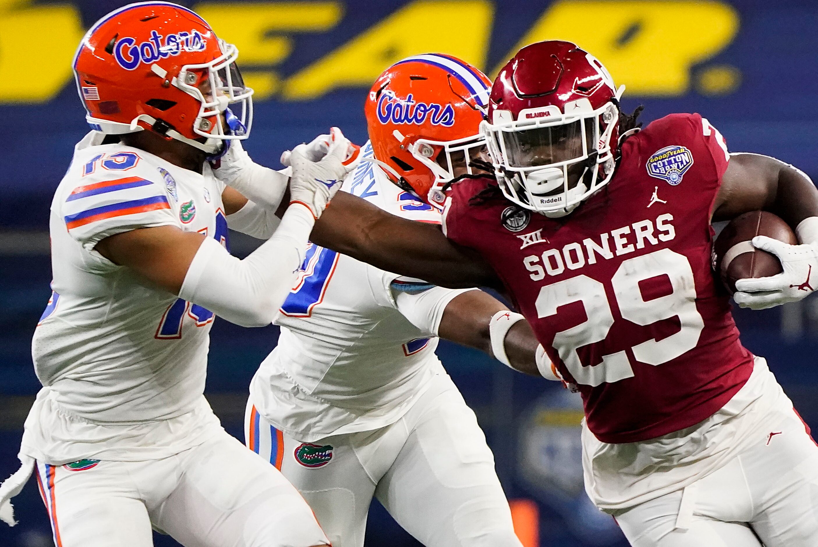 Oklahoma running back Rhamondre Stevenson (29) pushes past Florida defensive back Donovan...