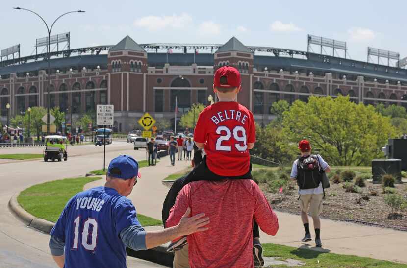 Three generations of baseball fans head to the stadium for mopening day--grandfather Mike...