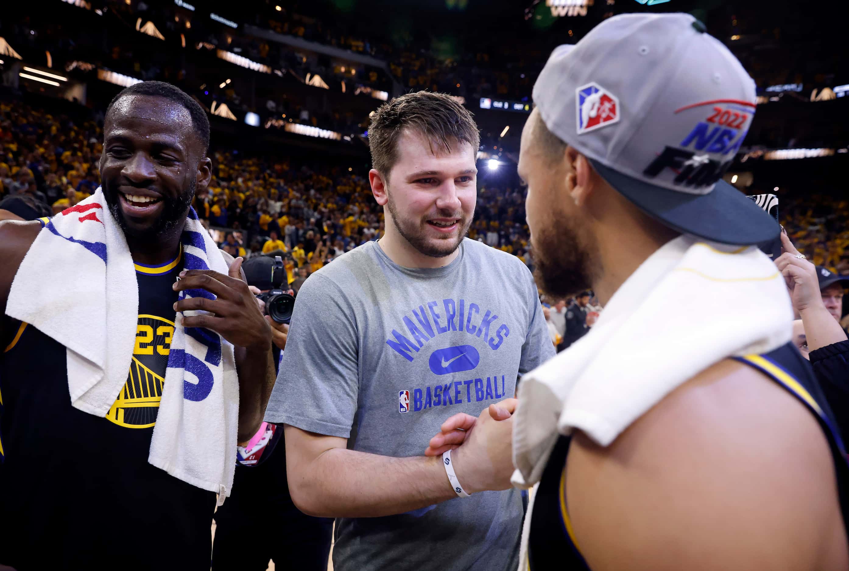 Dallas Mavericks guard Luka Doncic (center) congratulates Golden State Warriors guard...